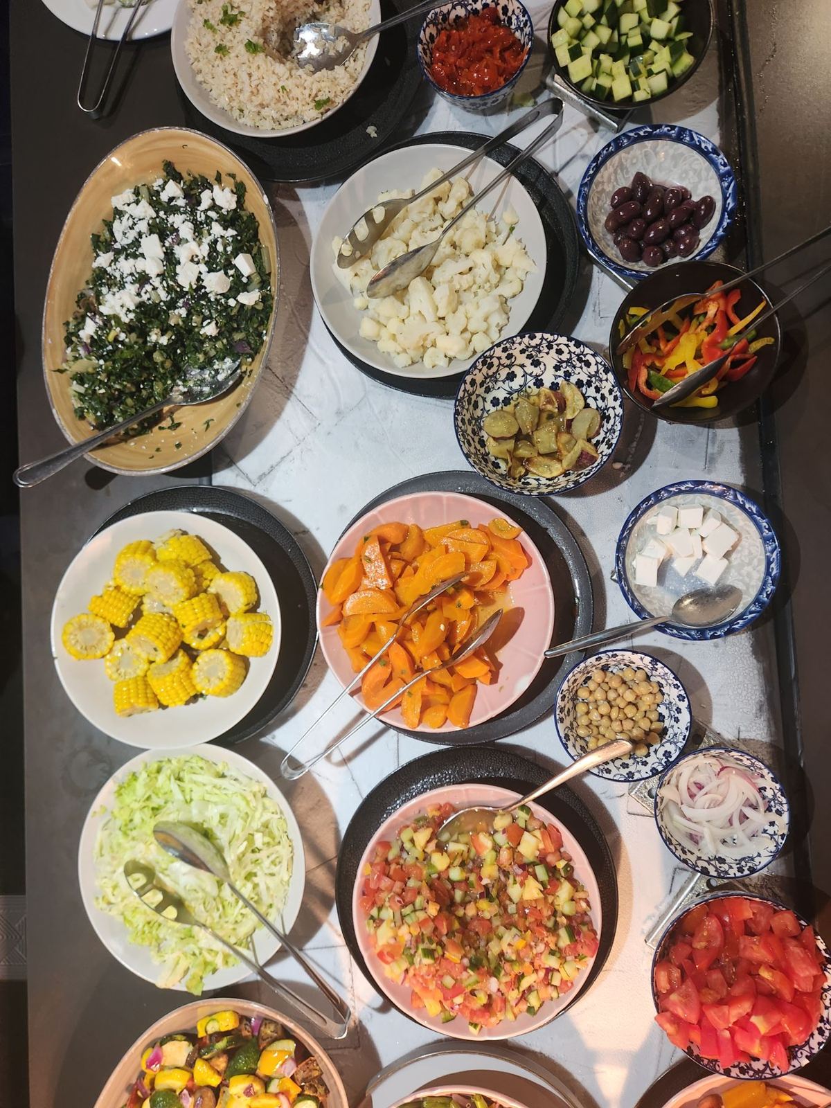 A Mediterranean spread of salads, olives, feta and roasted vegetables