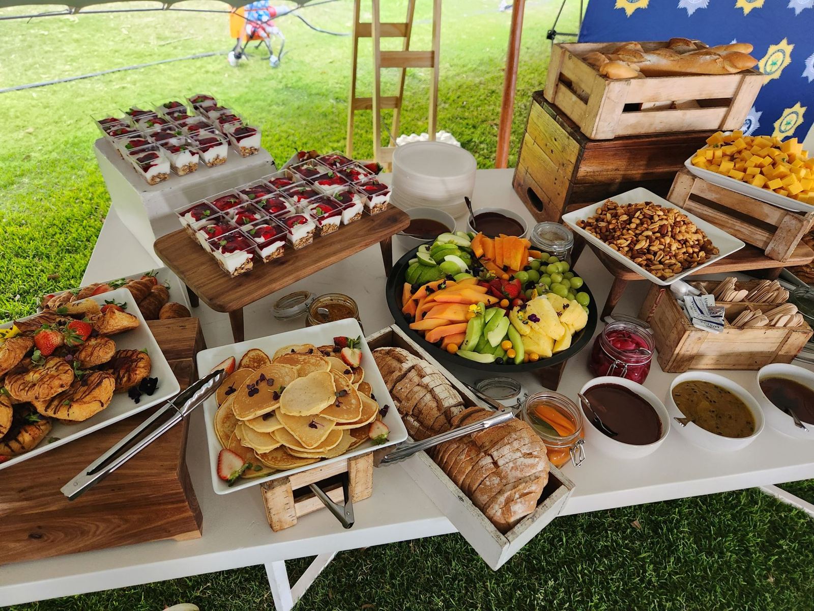 An outdoor dessert and snack table on wooden crates