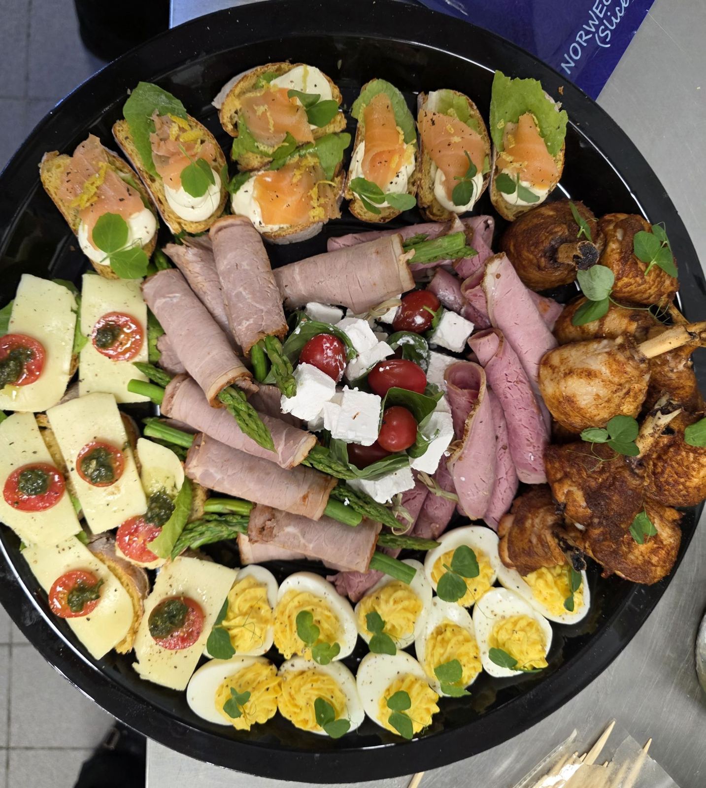 A platter of smoked salmon, cold meats, cheese, devilled eggs and pastries