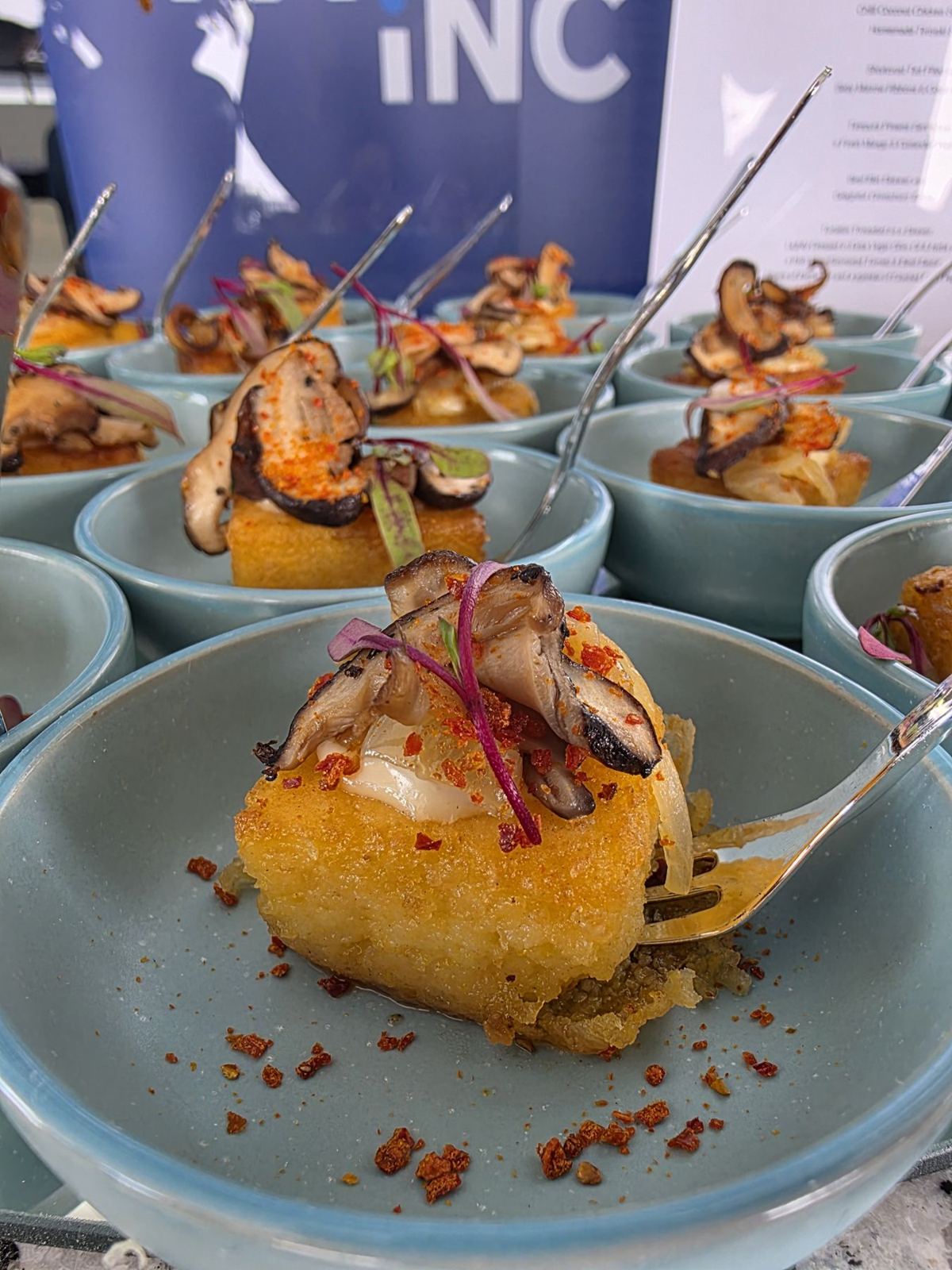 Crisp polenta topped with roasted mushrooms in pale blue bowls