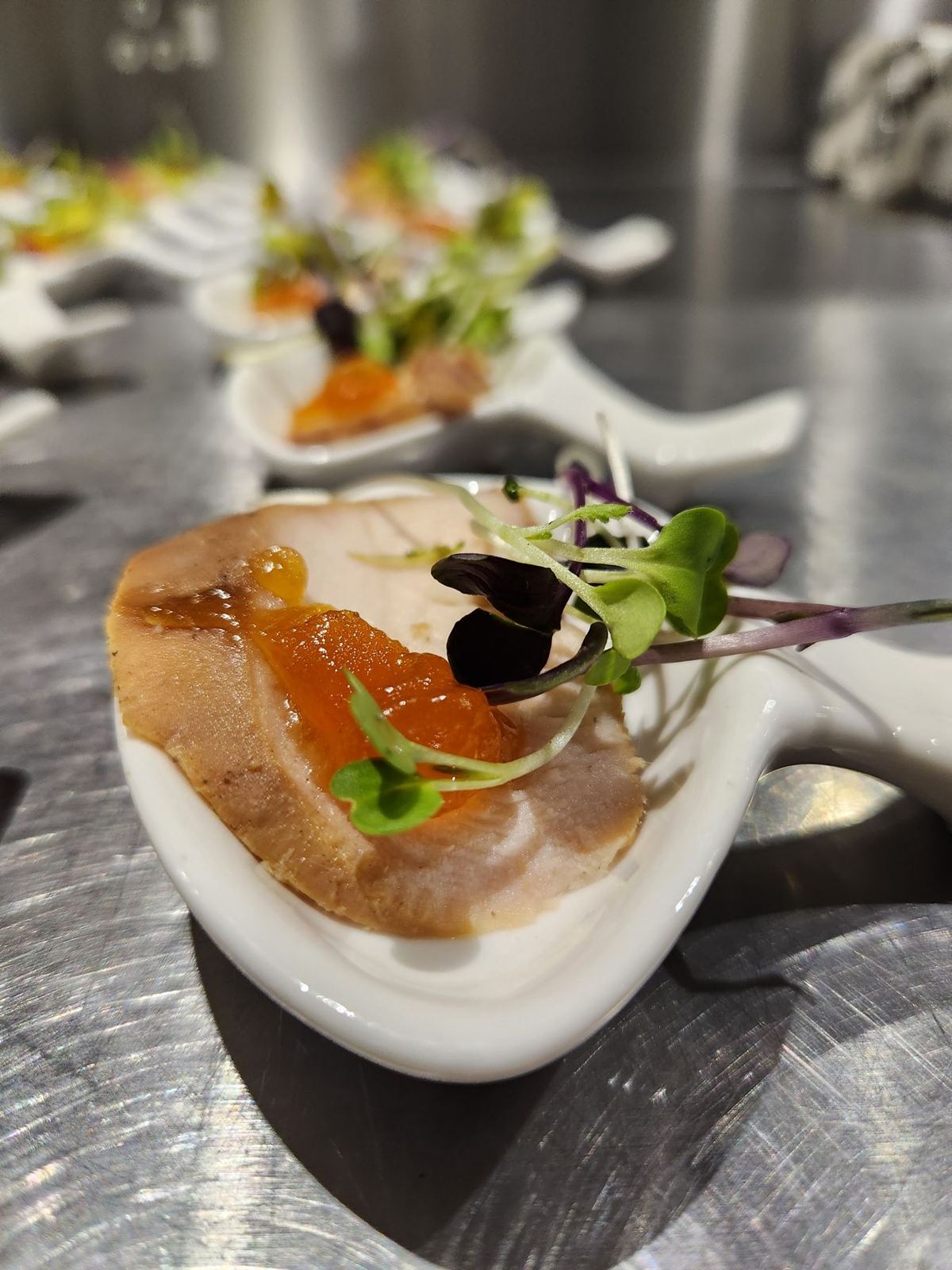 A canapé spoon with smoked salmon, apricot and micro herbs